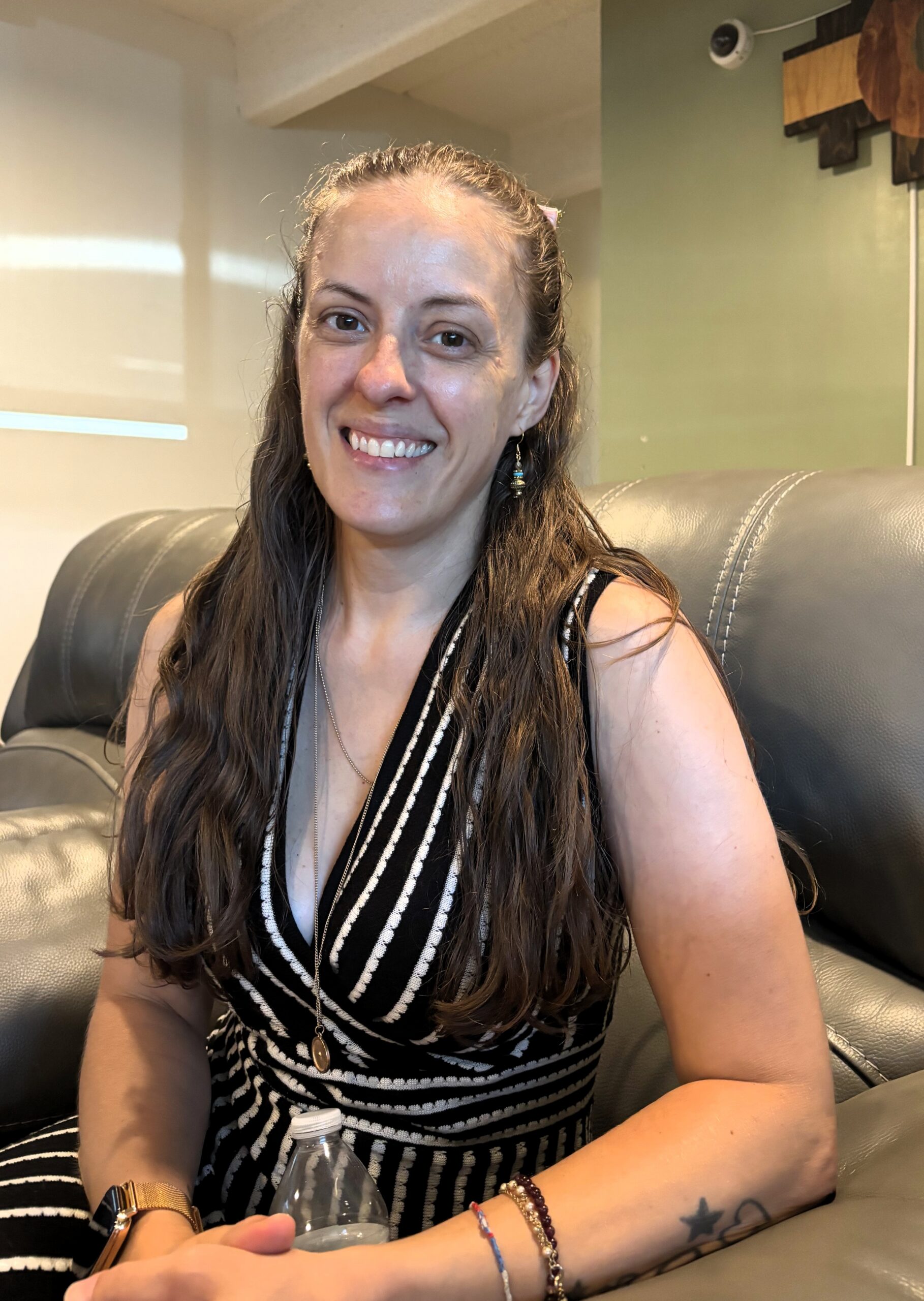 Cassandra smiling while seated in the lobby at RecoveryWorks Cassandra
